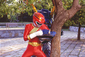 Red Ranger fights free of Vacuum Cleaner Org's attack