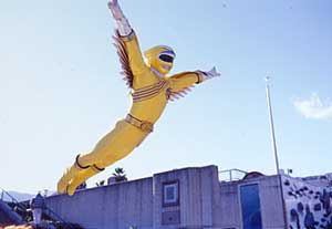 Yellow Ranger flying through the air